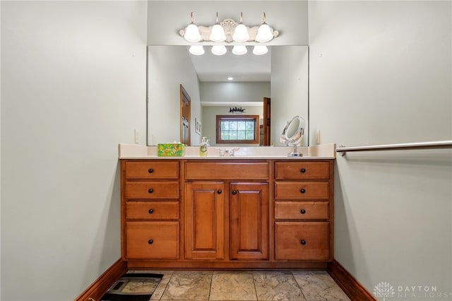 bathroom featuring baseboards and vanity