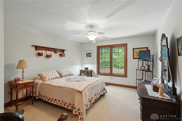 carpeted bedroom with baseboards and ceiling fan