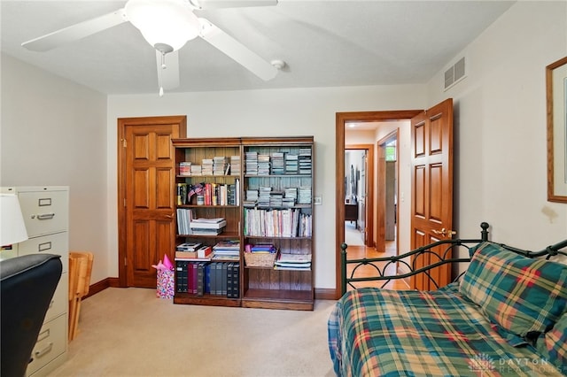 bedroom featuring baseboards, light carpet, and visible vents