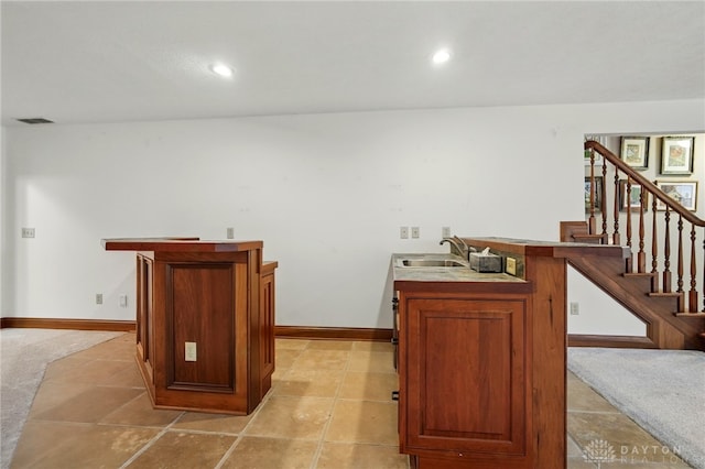 bar with visible vents, stairs, recessed lighting, bar, and a sink