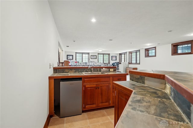 bar featuring a sink, bar, fridge, and recessed lighting