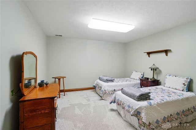 carpeted bedroom with baseboards and visible vents