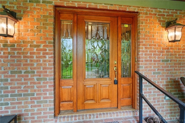 property entrance featuring brick siding