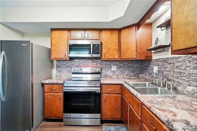 317 Ironwood Dr, West Carrollton, OH 45449 - kitchen featuring appliances with stainless steel finishes, a sink, and brown cabinetry