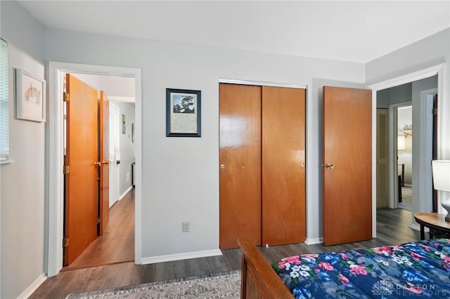 317 Ironwood Dr, West Carrollton, OH 45449 - bedroom with wood finished floors, a closet, and baseboards