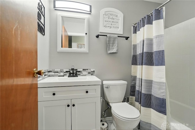 317 Ironwood Dr, West Carrollton, OH 45449 - bathroom featuring toilet, vanity, shower / bath combo with shower curtain, and backsplash