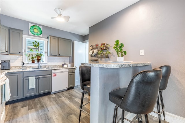 19 Klee Ave, Dayton, OH 45403 - kitchen with white dishwasher, gray cabinetry, and a breakfast bar