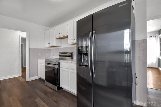 kitchen with stainless steel range with electric stovetop, light countertops, white cabinetry, fridge with ice dispenser, and dark wood-type flooring