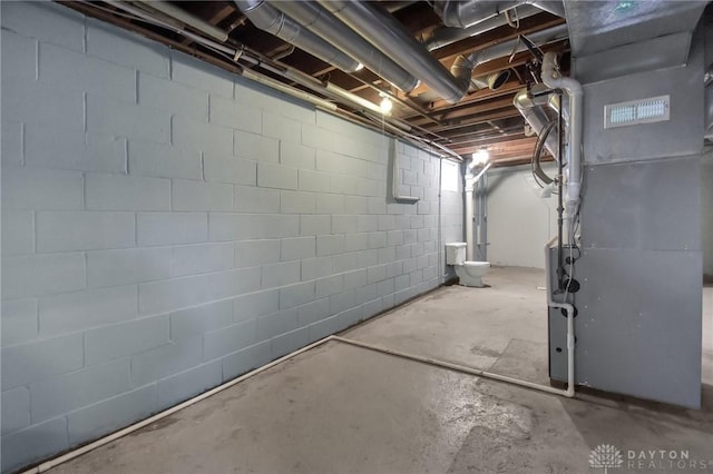 unfinished basement featuring heating unit