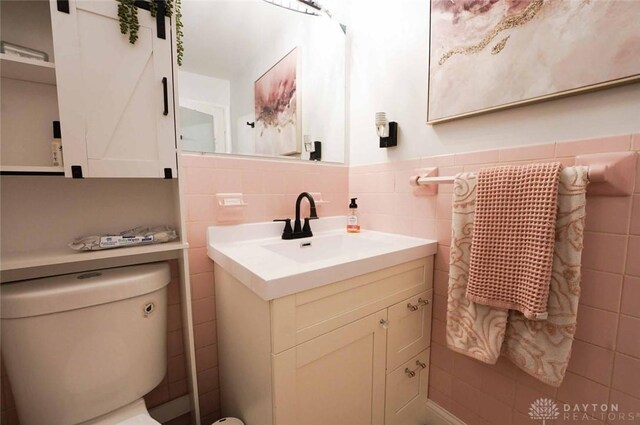 403 W Rahn Rd, Dayton, OH 45429 - half bathroom featuring tile walls, vanity, and toilet