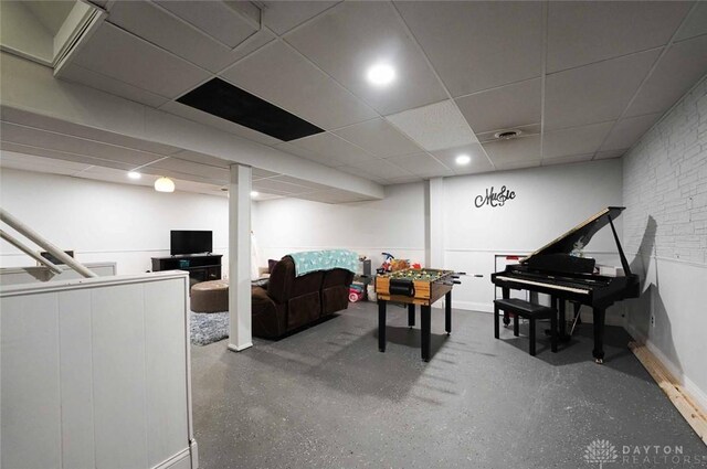 403 W Rahn Rd, Dayton, OH 45429 - living area featuring speckled floor, baseboards, and a paneled ceiling