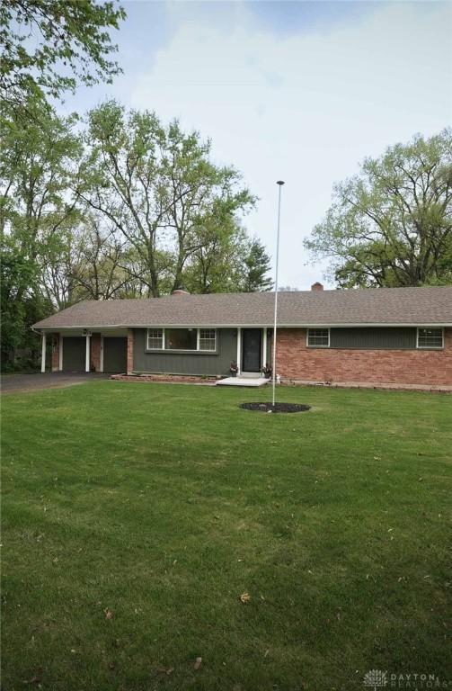 403 W Rahn Rd, Dayton, OH 45429 - ranch-style home featuring a garage, driveway, and a front lawn