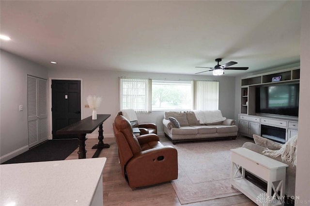 403 W Rahn Rd, Dayton, OH 45429 - living room featuring built in features, baseboards, ceiling fan, light wood-type flooring, and recessed lighting