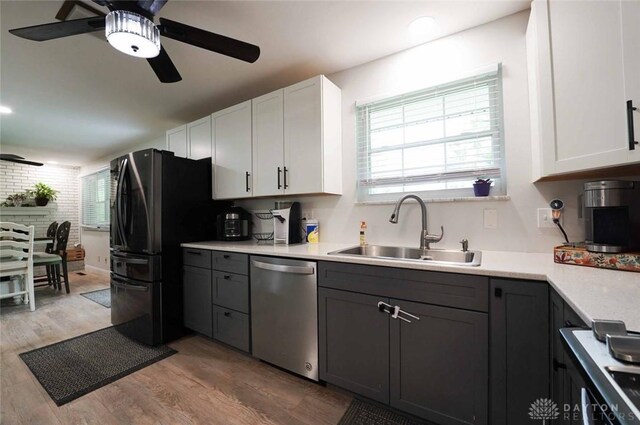 403 W Rahn Rd, Dayton, OH 45429 - kitchen with ceiling fan, light countertops, a sink, light wood finished floors, and dishwasher