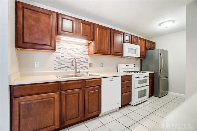 3087 Westminster Dr Unit 101, Beavercreek, OH 45431 - kitchen with backsplash, a sink, light countertops, white appliances, and light tile patterned flooring