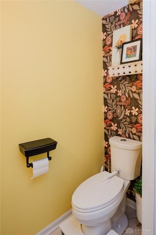 bathroom featuring toilet and baseboards