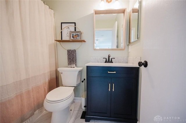 bathroom featuring toilet, tile patterned floors, a shower with shower curtain, and vanity