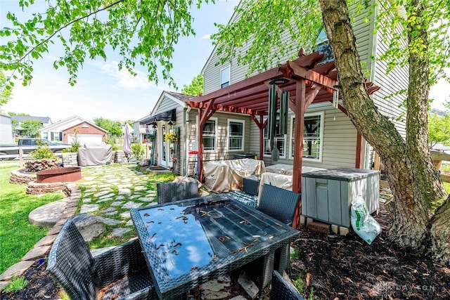 back of property with an outdoor structure, outdoor dining area, and a patio