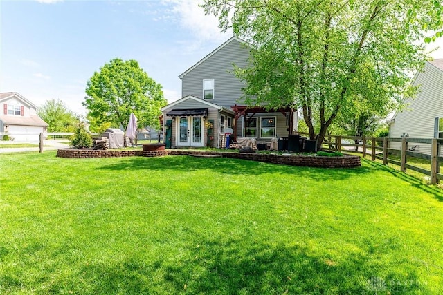 exterior space featuring fence private yard, a yard, french doors, and a patio