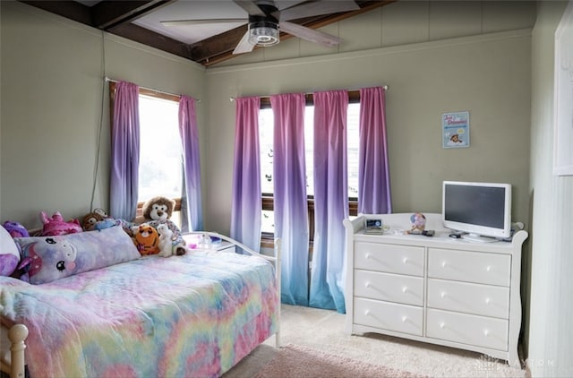 bedroom with beamed ceiling, light colored carpet, and ceiling fan