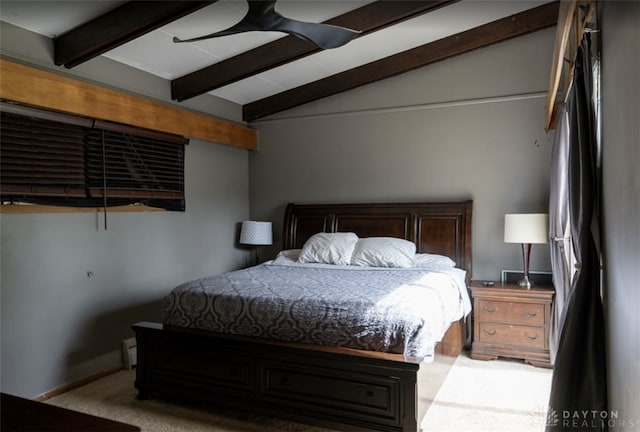 bedroom with vaulted ceiling with beams and carpet flooring