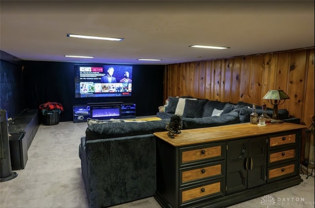 cinema featuring wood walls and light carpet