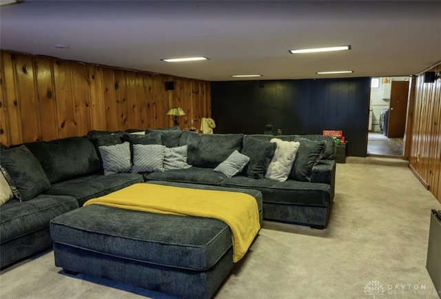 living room with wood walls and light carpet
