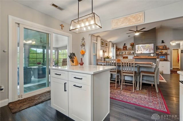 2481 Byers Ridge Dr, Miamisburg, OH 45342 - kitchen featuring visible vents, lofted ceiling, a center island, white cabinets, and dark wood finished floors