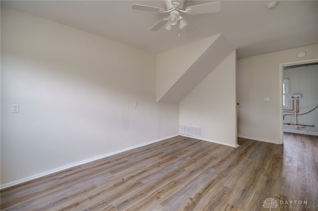 additional living space featuring visible vents, baseboards, ceiling fan, and wood finished floors
