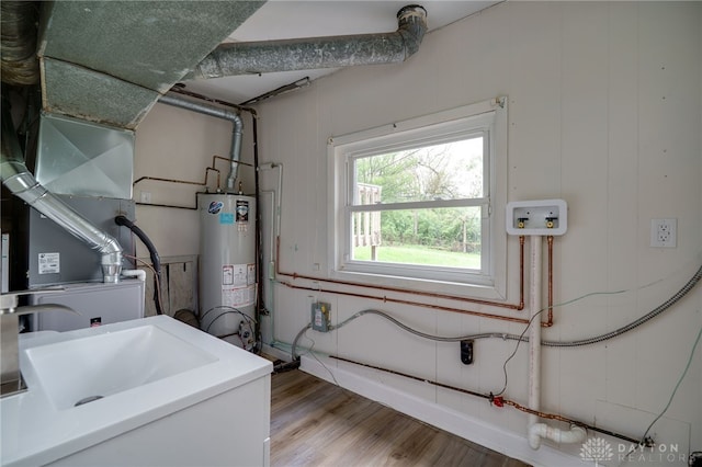 utility room featuring a sink and gas water heater