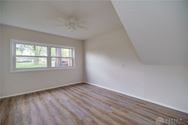 empty room featuring baseboards, a ceiling fan, and wood finished floors