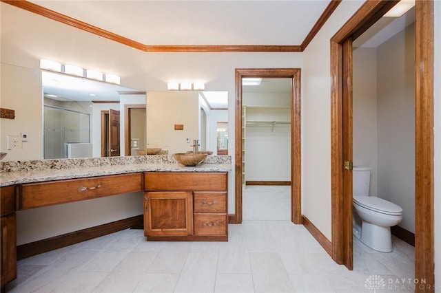 2940 Stonewall Dr, Beavercreek, OH 45434 - full bathroom with vanity, ornamental molding, a shower stall, and toilet