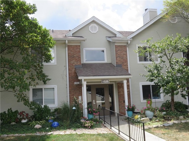 1520 Lake Pointe Way Unit 6, Centerville, OH 45459 - view of property featuring brick siding, a shingled roof, and a chimney
