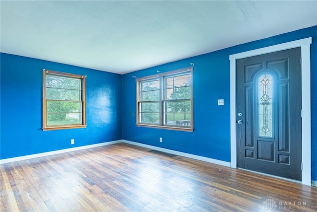 foyer with visible vents, baseboards, plenty of natural light, and hardwood / wood-style flooring