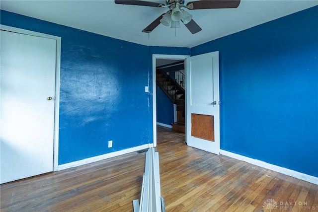 unfurnished bedroom with baseboards, ceiling fan, and wood finished floors