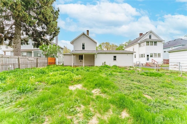 rear view of house with fence