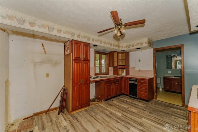 kitchen featuring light wood-style floors, decorative backsplash, a textured ceiling, and ceiling fan