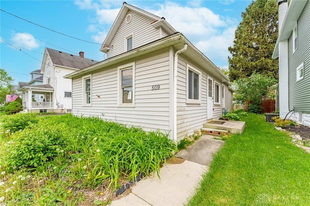 view of side of home featuring a yard