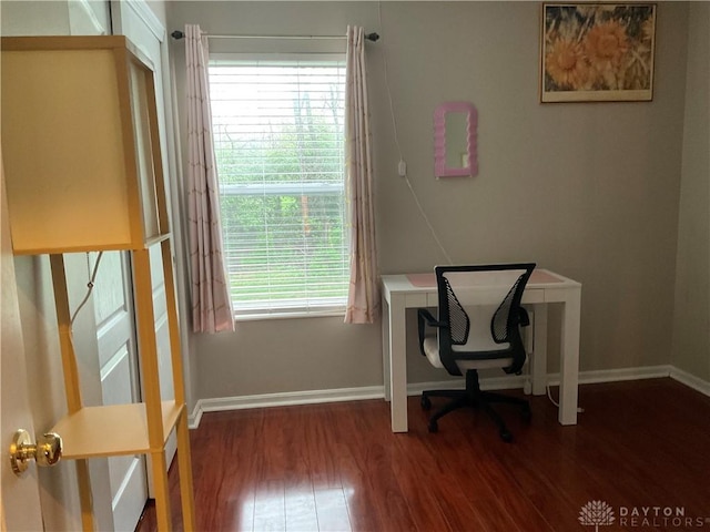 office space featuring baseboards and wood finished floors