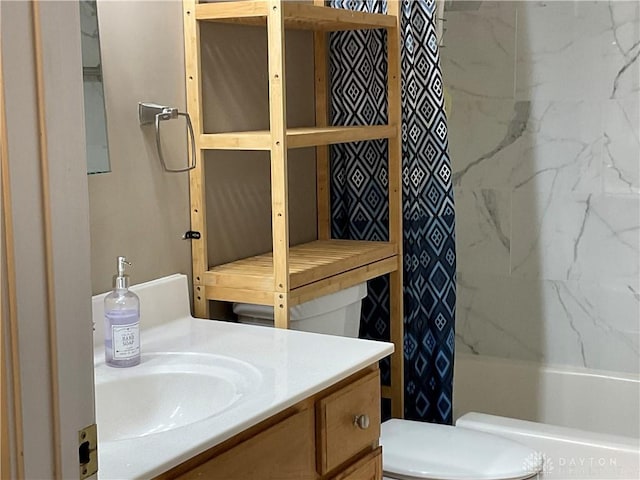 full bath with vanity, shower / bath combo with shower curtain, and toilet