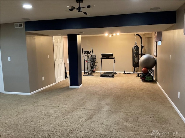 exercise room with carpet flooring, baseboards, and visible vents