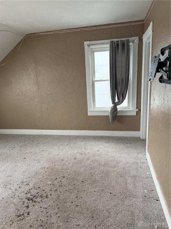 1080 Linden Ave, Dayton, OH 45410 - additional living space with carpet flooring, a textured wall, lofted ceiling, and baseboards