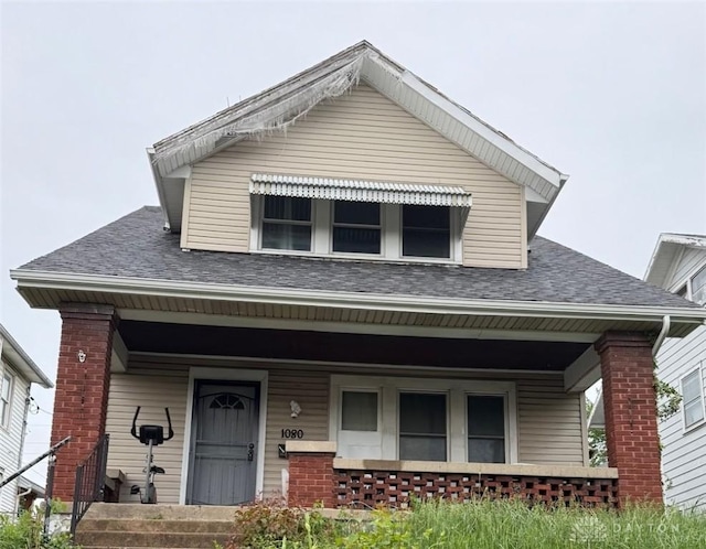 1080 Linden Ave, Dayton, OH 45410 - view of front of home featuring covered porch, brick siding, and a shingled roof