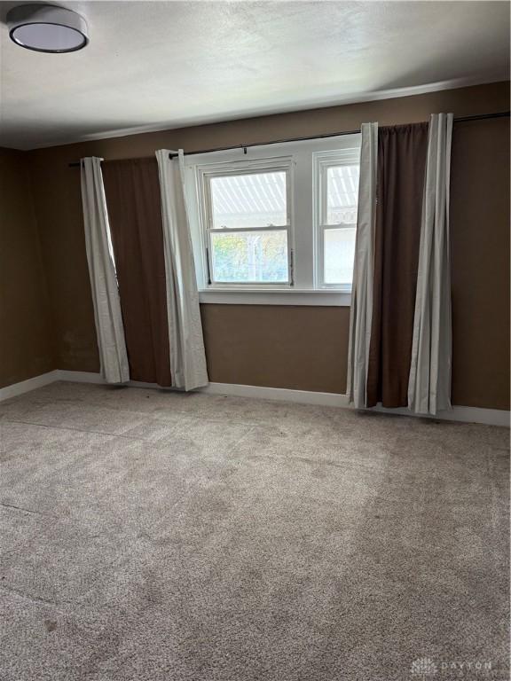 1080 Linden Ave, Dayton, OH 45410 - spare room featuring baseboards and carpet