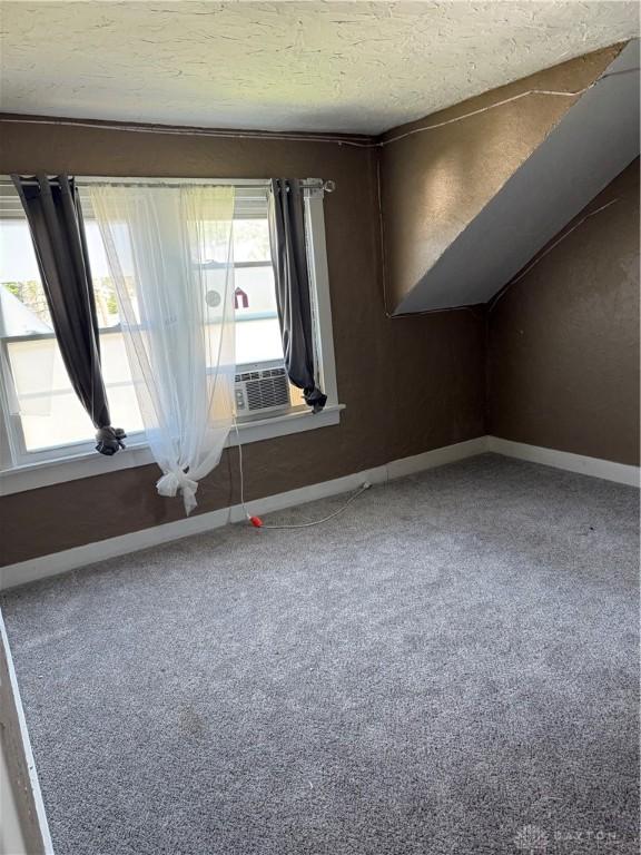 1080 Linden Ave, Dayton, OH 45410 - additional living space featuring baseboards, carpet floors, a textured ceiling, and cooling unit