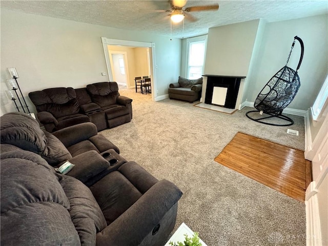 308 Park Ave, Harrison Twp, OH 45030 - living room with carpet floors, a textured ceiling, ceiling fan, and baseboards