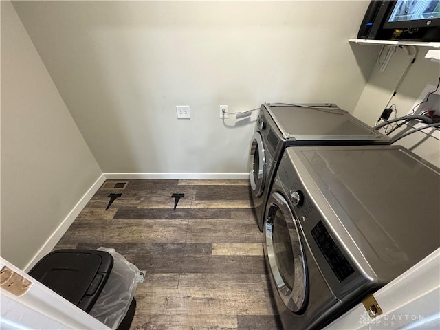 308 Park Ave, Harrison Twp, OH 45030 - clothes washing area featuring baseboards, laundry area, washing machine and dryer, and wood finished floors