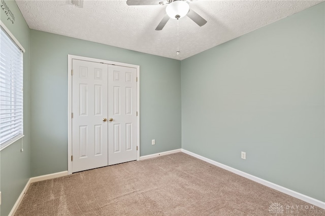 2750 Twin Lakes Dr, Troy, OH 45373 - unfurnished bedroom featuring a closet, carpet flooring, a textured ceiling, and baseboards