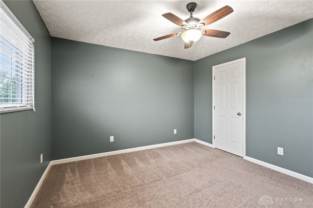 2750 Twin Lakes Dr, Troy, OH 45373 - carpeted spare room featuring a textured ceiling, baseboards, and ceiling fan