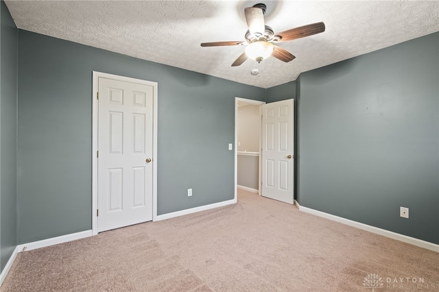2750 Twin Lakes Dr, Troy, OH 45373 - unfurnished bedroom featuring a textured ceiling, baseboards, carpet, and a ceiling fan